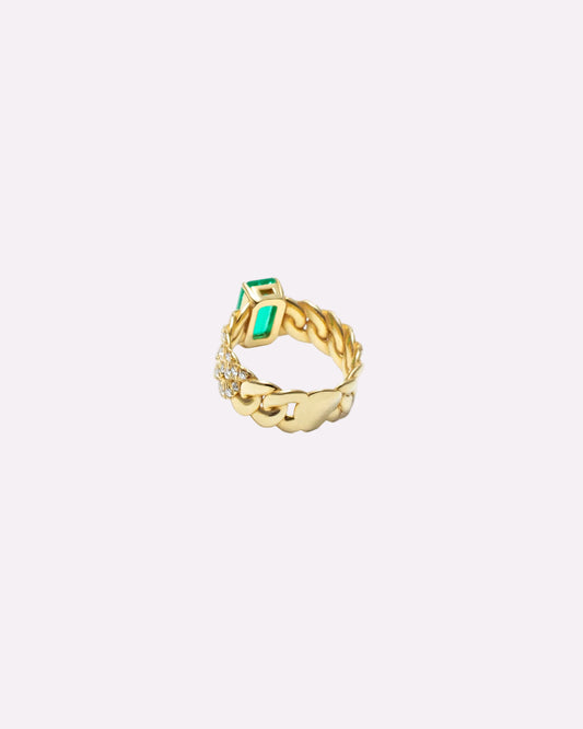 A gold ring with a textured, twisted band, featuring a rectangular green emerald-cut stone and a small cluster of clear pavé stones, shown on a plain white background.